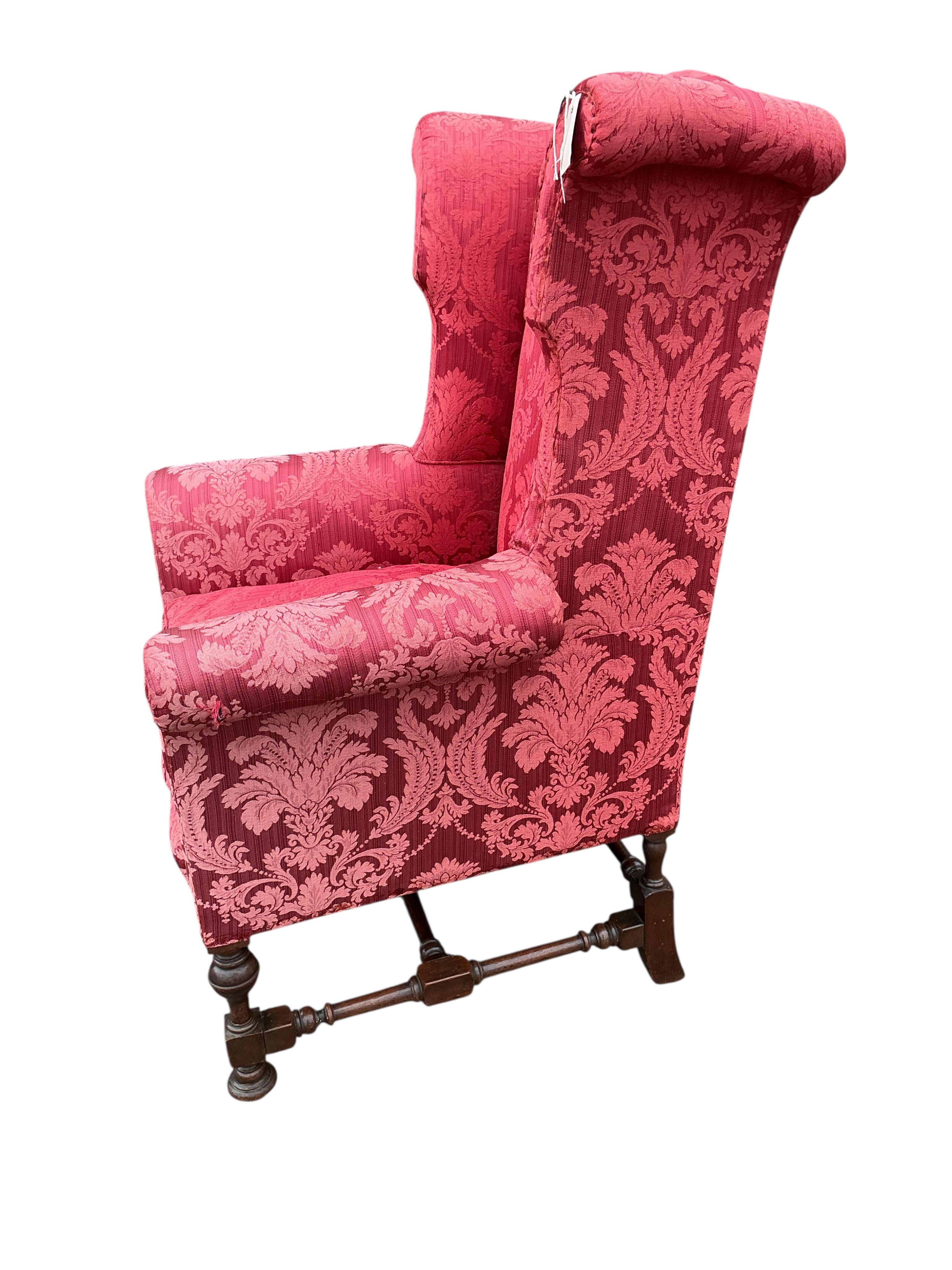 A pair of early 20th century Jacobean Revival upholstered wing armchairs, width 81cm, depth 75cm, height 127cm